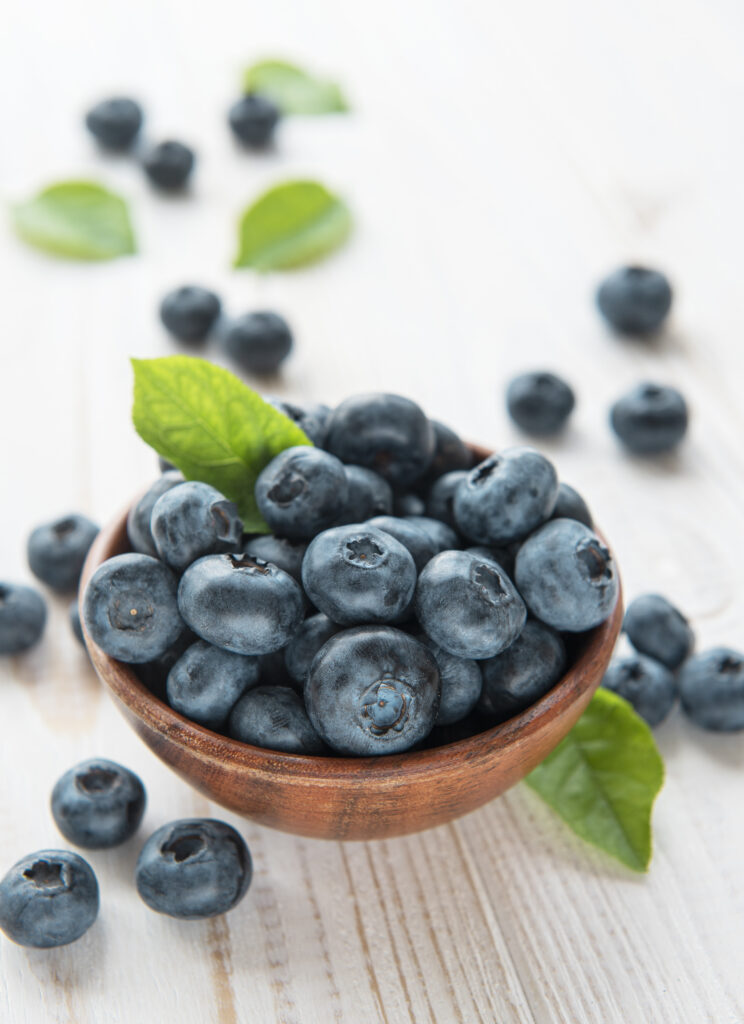 Freshly picked blueberries on a old wooden background. Concept for healthy eating