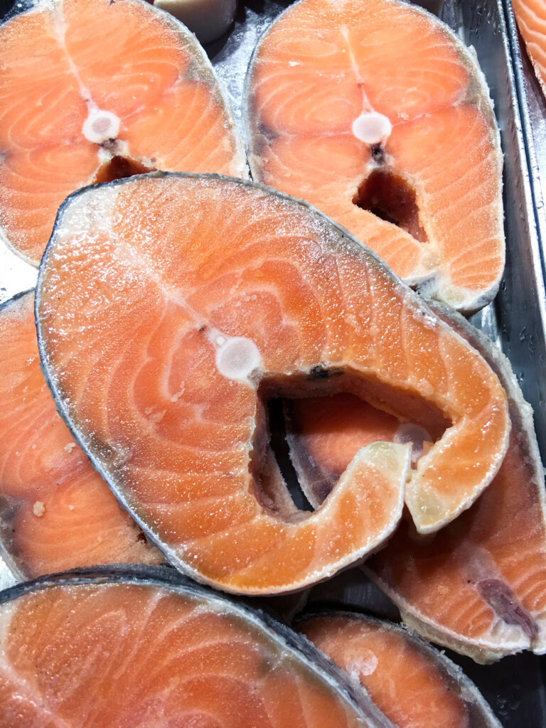 Salmon fish steak fresh in ice sell on market.