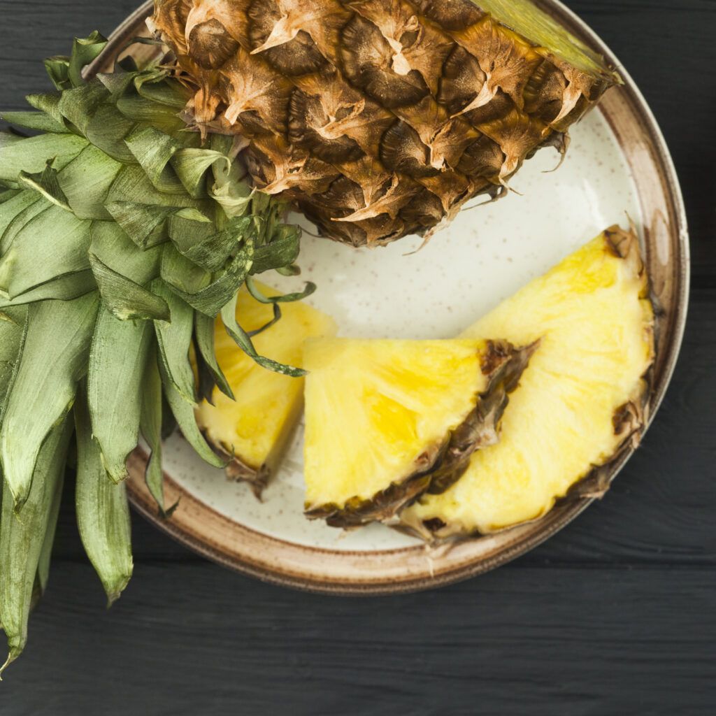 slices-pineapple-with-green-leaves-plate